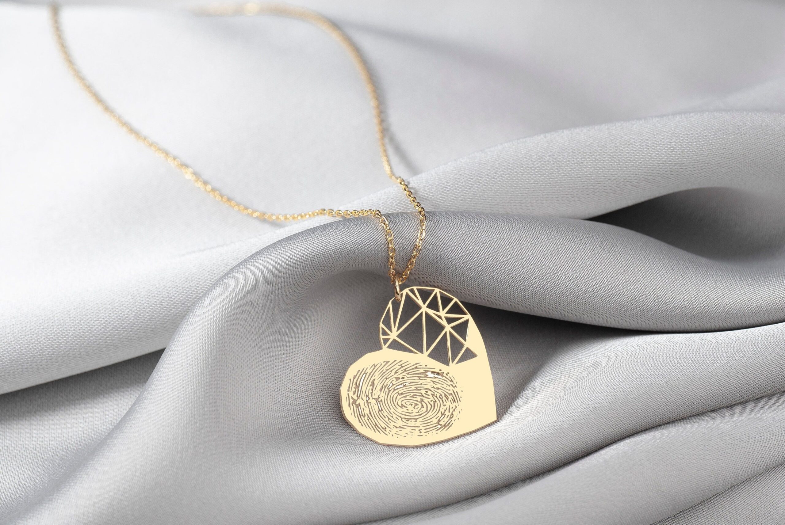 Close-up of a personalized gold Ahava jewelry piece being engraved